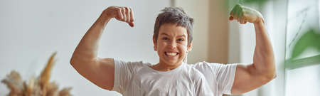 Happy boy taking exercising with strong fatherの写真素材