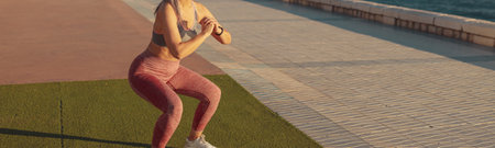 Healthy adult female exercising by the waterfront