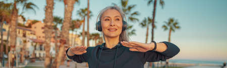 Sporty woman warming up before exercising on the seafrontの写真素材