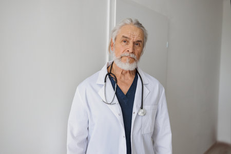 Portrait of professional doctor in uniform standing in medicine clinic hall and looking camera