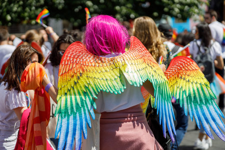Diverse people are walking on a gay pride parade on the city streets with flagsの写真素材