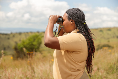 African American female guide looking for wildlifeの写真素材