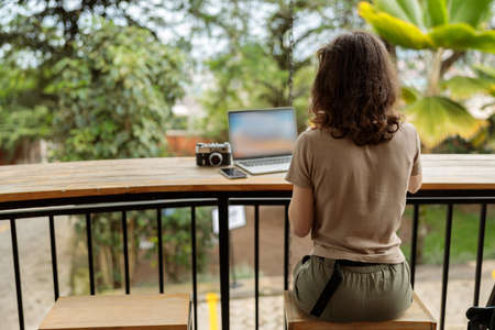 Young woman using laptop while working onlineの写真素材