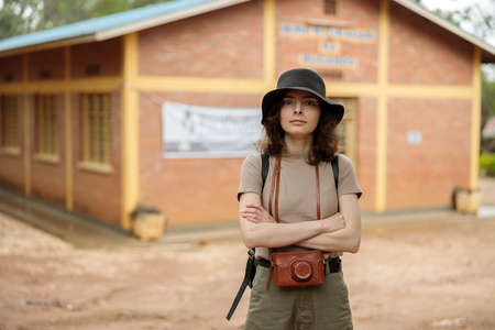 Female tourist in black hat crossed her arms