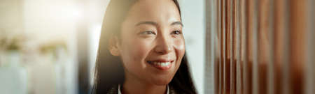 Portrait of attractive asian business woman standing in modern office. Blurred backgroundの写真素材