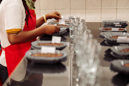 Woman placing notes on plates with coffee for tasting