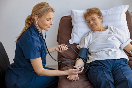 Doctor supporting a sick patient before medical procedures in a hospital roomの写真素材