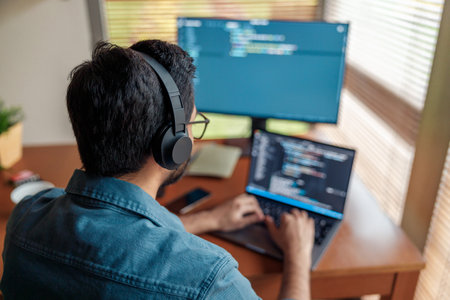 Male freelancer making new project as web designer or programmer on his computer at home office