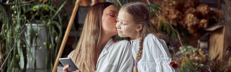 Happy caucasian mother with young beautiful cheerful daughter are having time together
