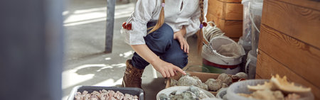 Portrait of a young happy smiling caucasian girl. Flourist shop with different kinds of dryed flowers.の写真素材