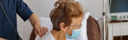 Doctor listening to old womans patient breathing, using stethoscope
