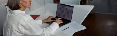 Focused european business woman working laptop while sitting in cozy cafe and looking awayの写真素材