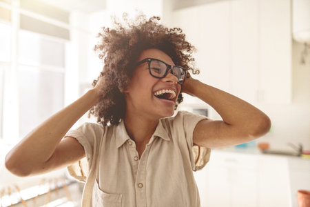 Smiling young lady wearing glasses and enjoying sunny dayの写真素材