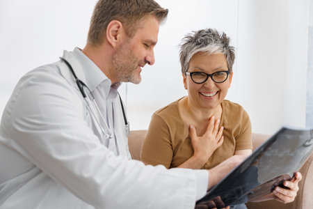 Doctor explaining x-ray result for female patient in hospital office. Healthcare concept