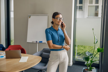 Ambitious Young Professional Woman Presented Within a Contemporary Office Settingの写真素材
