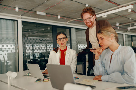 Engaging in Collaborative Teamwork within a Modern Office Environment for Productivity and Successの写真素材