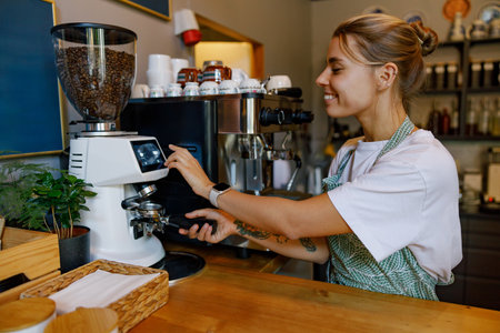 Coffee Shop Barista Preparing a Fresh Brew in a Cozy Cafの写真素材