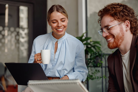 Participative and Inclusive Meeting in a Contemporary Workspace Equipped with Laptopsの写真素材