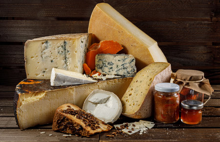 A selection of artisanal cheeses presented with various accompaniments to enhance flavorsの写真素材