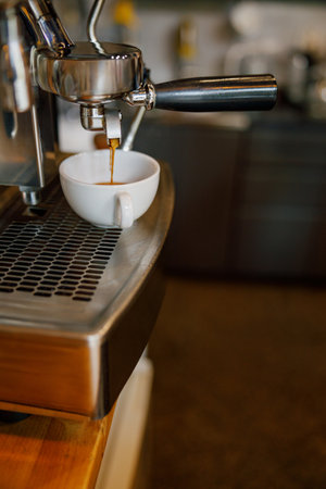 The Espresso Machine Skillfully Pouring Freshly Brewed Coffee with Rich Aroma and Flavorの写真素材