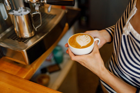 Skilled Barista Expertly Crafting Stunning Latte Art with Exceptionally Freshly Brewed Coffeeの写真素材