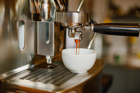 Experience a Freshly Brewed Espresso Shot Made with a Modern Coffee Machine for the Perfect Aromaの写真素材