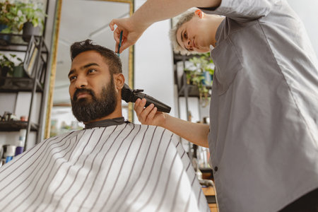 A skilled barber providing a classic gentlemans haircut at a stylish, modern salon setting,