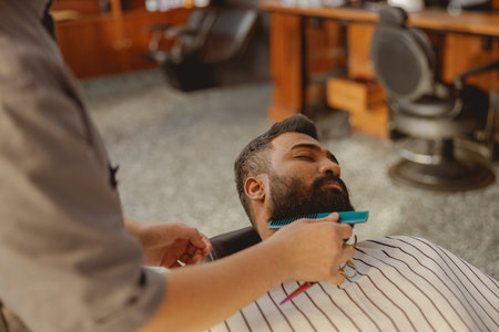 Experienced and professional barber offering topnotch shaving services in a modern salon setting