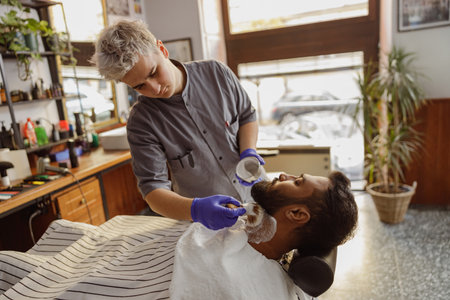 Enjoy a relaxing barber visit with premium shaving at a modern shop focused on your comfortの写真素材