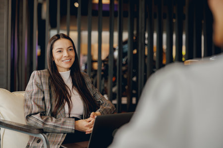 A Professional Business Meeting Taking Place in a Modern Office Setting with Various Attendeesの写真素材