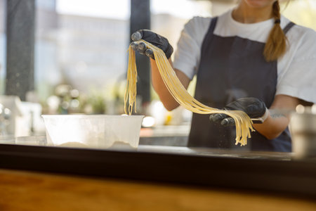 Crafting Fresh Pasta in a Cozy and Inviting Kitchen Environment That is Filled with Joyの写真素材