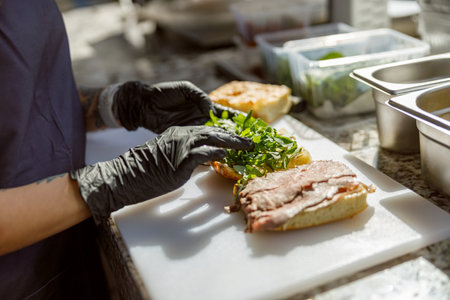 Creating a Delicious Fresh Sandwich with Extreme Care and Attention to Precisionの写真素材