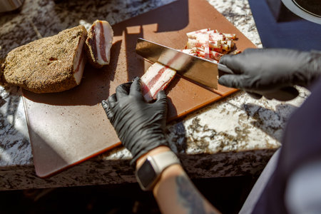 A skilled chef meticulously preparing fresh ingredients with precision on a cutting boardの写真素材