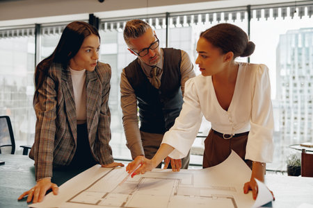 Team Collaboration on Architectural Plans in a Modern and Innovative Office Environment