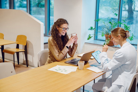 Two Professionals Engaged in Collaborative Work in a Contemporary and Modern Workspace Environment