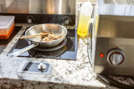Cooking on a Modern Kitchen Countertop Using Fresh, Quality Ingredients for Delicious Mealsの写真素材