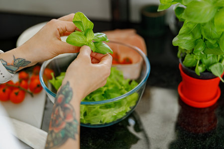 Preparation of a Fresh Salad that is made with Organic Ingredients for a Healthy Mealの写真素材