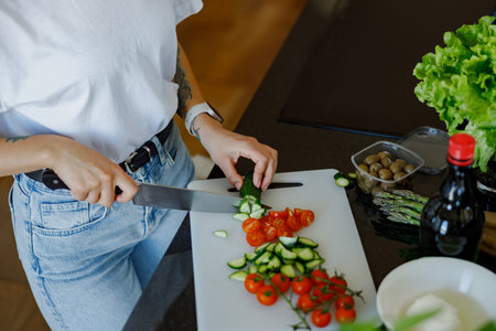 Healthy Cooking Skillfully Slicing Fresh, Colorful Vegetables in the Modern Kitchen