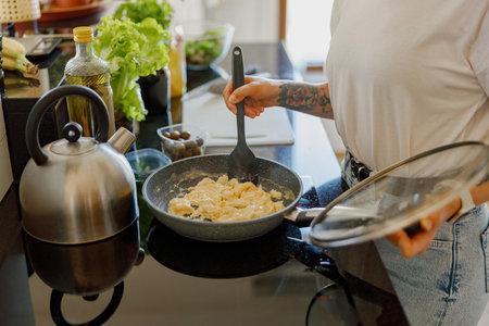 Prepare Delicious Pasta with Fresh Ingredients in a Modern, WellEquipped Kitchen Spaceの写真素材
