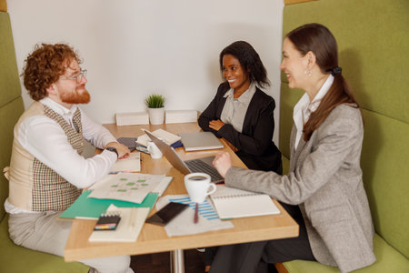A Business Meeting in a Modern Workspace Featuring a Diverse and Collaborative Team