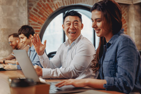 Engaging in Collaborative Teamwork Within a Modern and Dynamic Workspace Environmentの写真素材