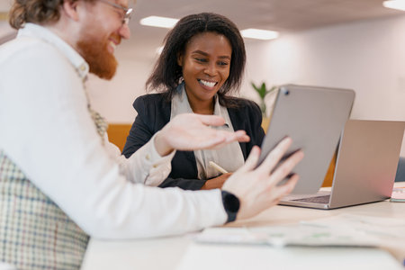 Participating in an Engaging Business Meeting Utilizing a Tablet in a Modern Office Workspaceの写真素材