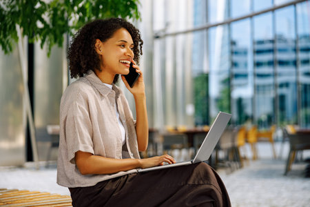 A Professional Woman Engaged in Work Remotely Within a Contemporary Office Setupの写真素材
