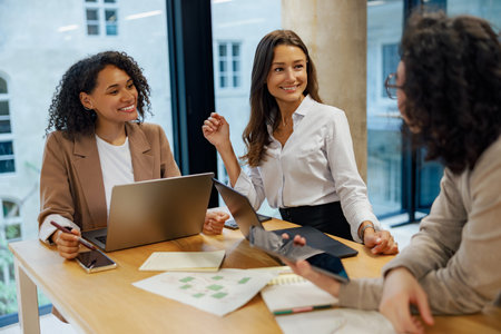 Engaging in Diverse Business Meeting Collaboration within a Modern Office Environmentの写真素材