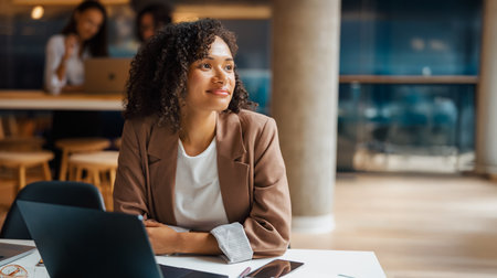 A Thoughtful Woman in a Contemporary Office Environment Reflecting on Her Ambitions and Ideas