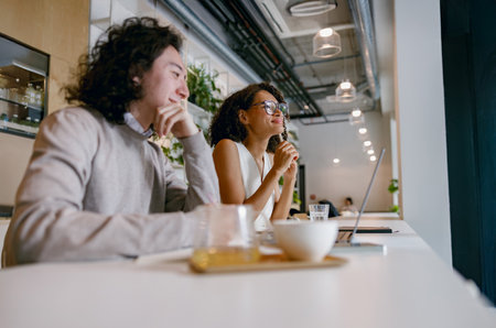 contemplative coffee break, relaxed work coffee setting, serene moment with laptop and warm ambianceの写真素材
