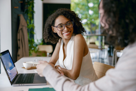 casual work discussion, genuine conversation amid tranquil ambiance with natural light and plants