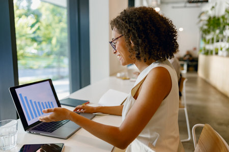 female professional engages with visual data representation during insightful meeting in vibrantの写真素材