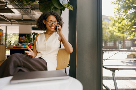 businesswoman multitasking actively, female professional juggling conversation and agenda at meetingの写真素材