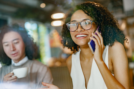 casual cafe interaction, authentic snapshot of remote work life with cheerful coworkers in hipの写真素材